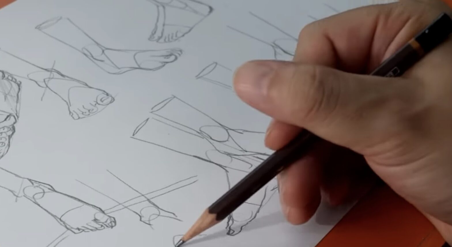 An artist's hand sketching various studies of human feet and hands