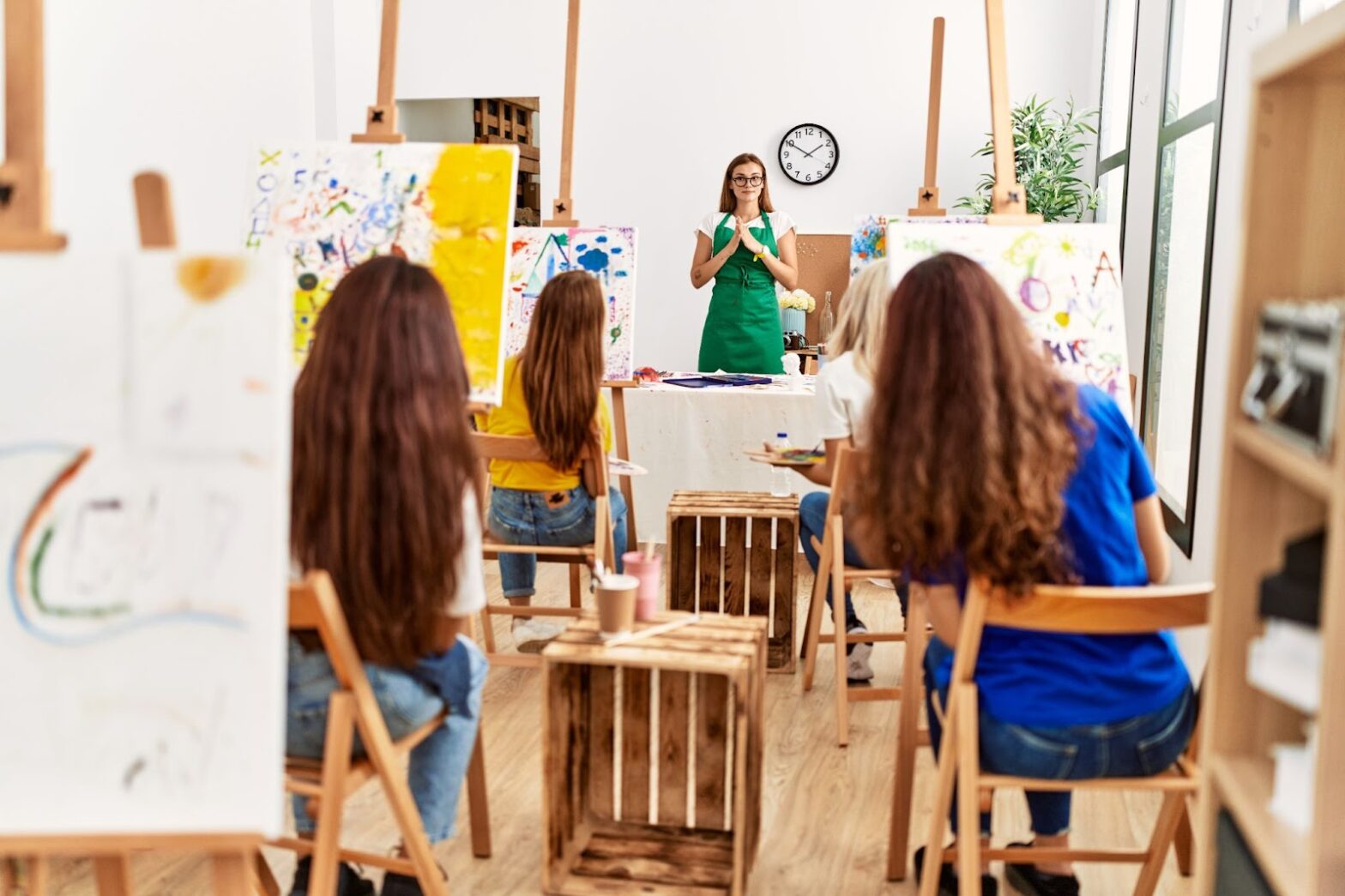 Group of young artist girls having draw lesson at art studio