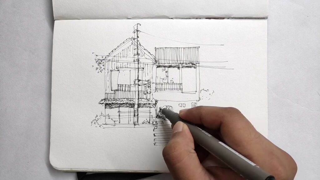 man drawing with pens